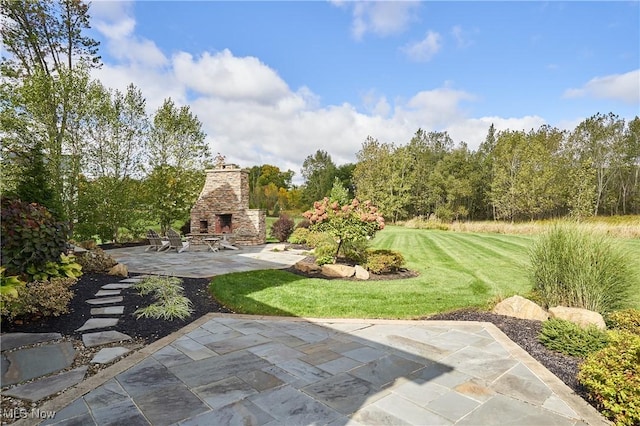 view of patio featuring an outdoor stone fireplace