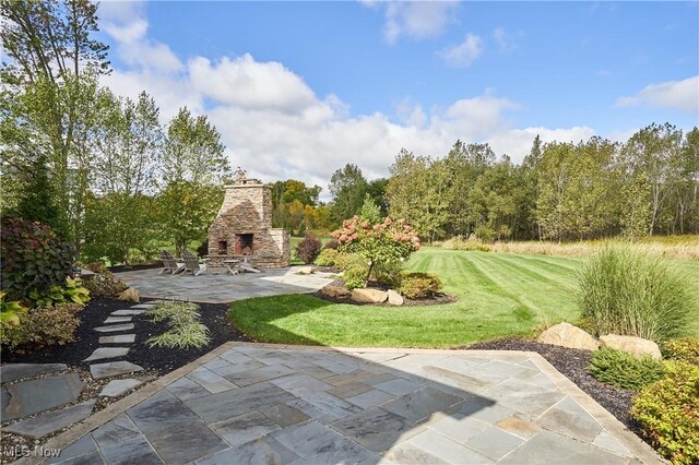 view of patio / terrace featuring an outdoor stone fireplace