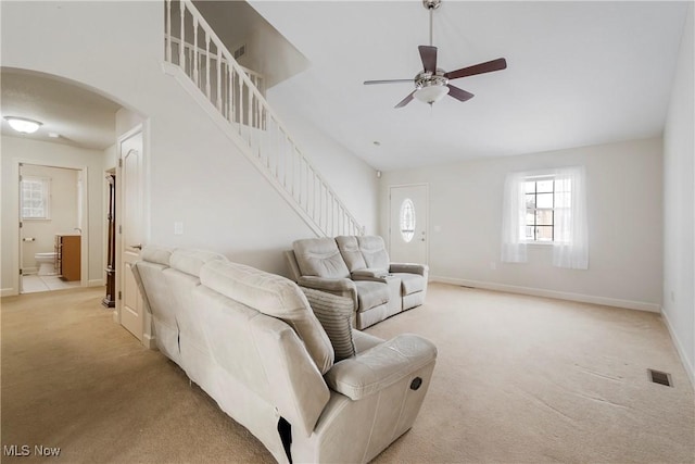 carpeted living room featuring ceiling fan