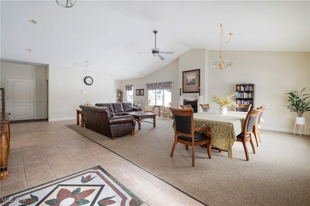 dining area with ceiling fan, light tile patterned flooring, and vaulted ceiling