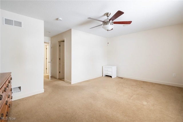 carpeted empty room featuring ceiling fan