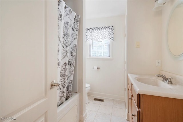 full bathroom with tile patterned floors, shower / bath combo with shower curtain, vanity, and toilet