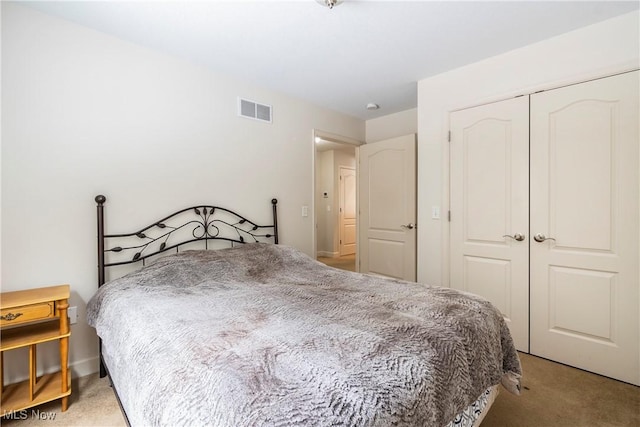 bedroom with light carpet and a closet