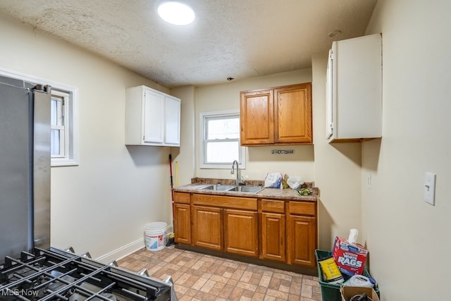 kitchen with sink and a textured ceiling