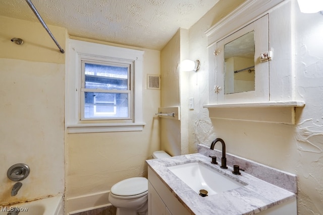 full bathroom with vanity, shower / tub combination, a textured ceiling, and toilet