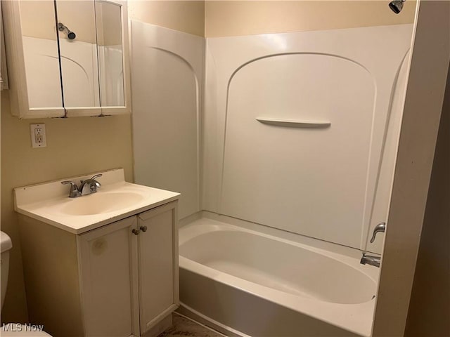 full bathroom featuring toilet, vanity, and bathing tub / shower combination