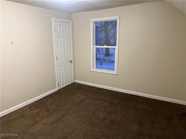 carpeted spare room with a textured ceiling