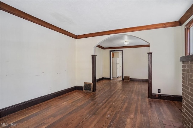 empty room featuring dark hardwood / wood-style flooring and crown molding