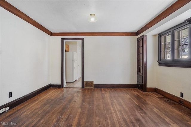 unfurnished room with dark hardwood / wood-style flooring and crown molding