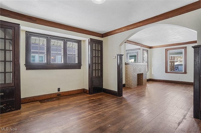 unfurnished living room featuring a fireplace and dark wood-type flooring