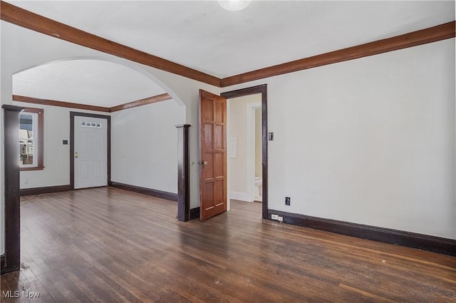 unfurnished room with dark wood-type flooring