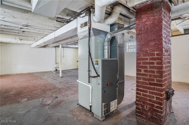 utility room featuring heating unit