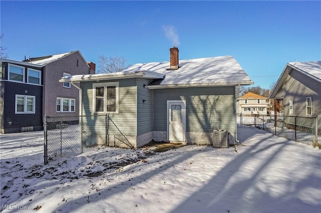 snow covered property featuring cooling unit