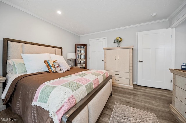 bedroom featuring ornamental molding and dark wood-type flooring