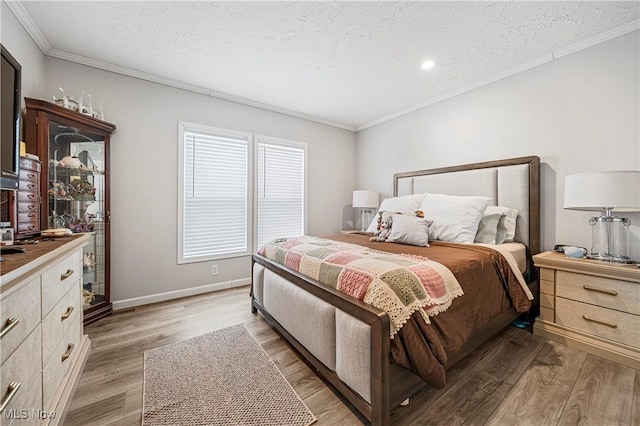 bedroom featuring light wood-type flooring, a textured ceiling, and ornamental molding