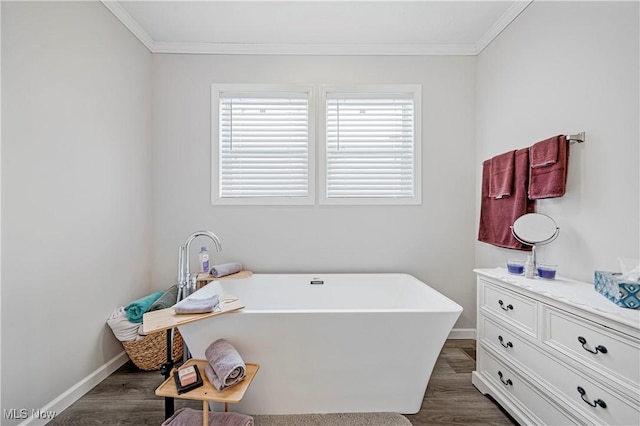 bathroom with a bath, crown molding, and wood-type flooring