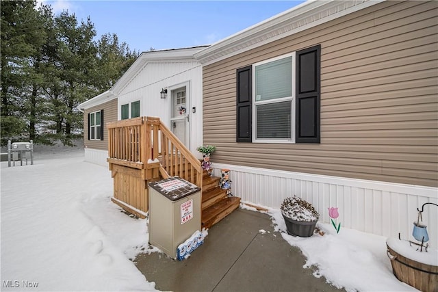 view of snow covered property entrance