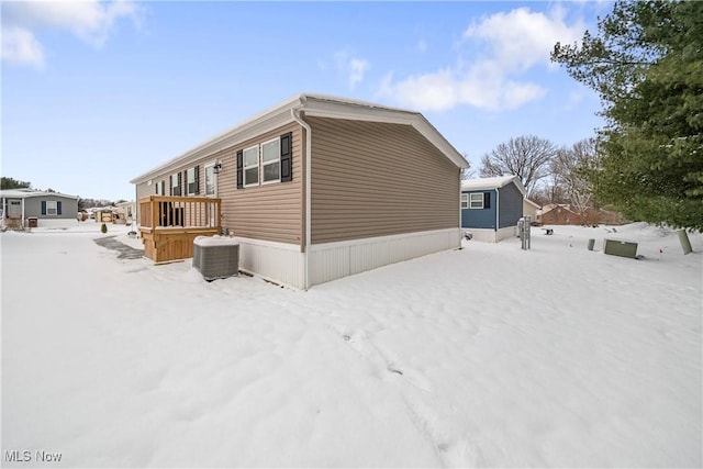 view of snow covered exterior featuring central AC