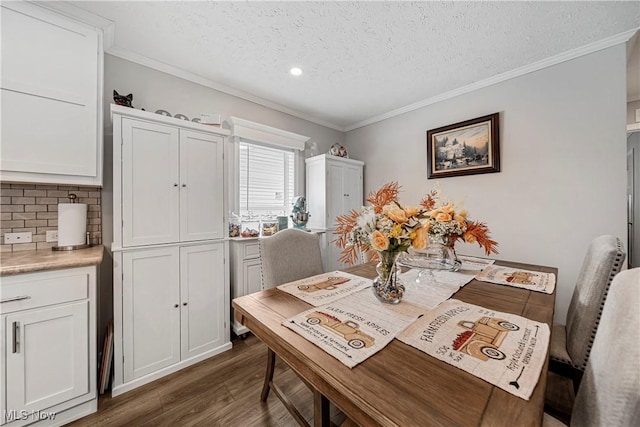 dining area with dark hardwood / wood-style floors, crown molding, and a textured ceiling