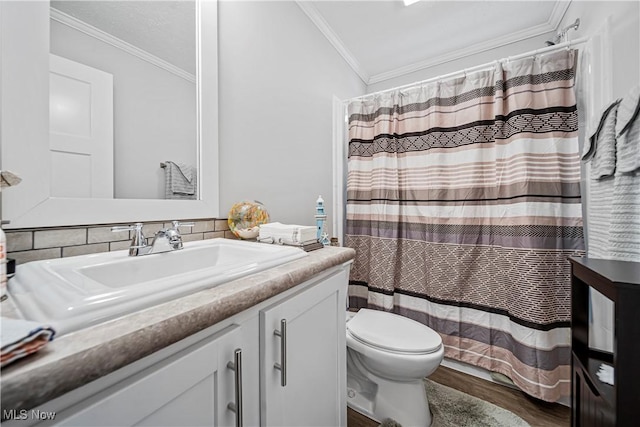 bathroom with backsplash, vanity, crown molding, hardwood / wood-style floors, and toilet