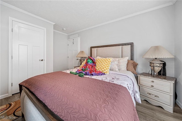 bedroom with wood-type flooring and ornamental molding