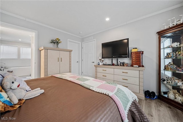 bedroom featuring wood-type flooring and ornamental molding