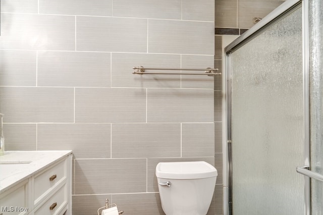 full bathroom featuring vanity, toilet, and a stall shower