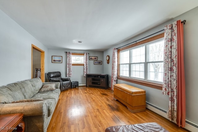 living room with a baseboard radiator and light wood-style floors