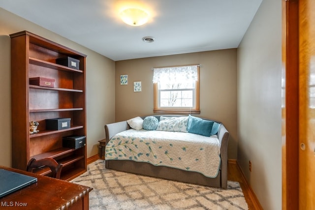 bedroom featuring visible vents and baseboards