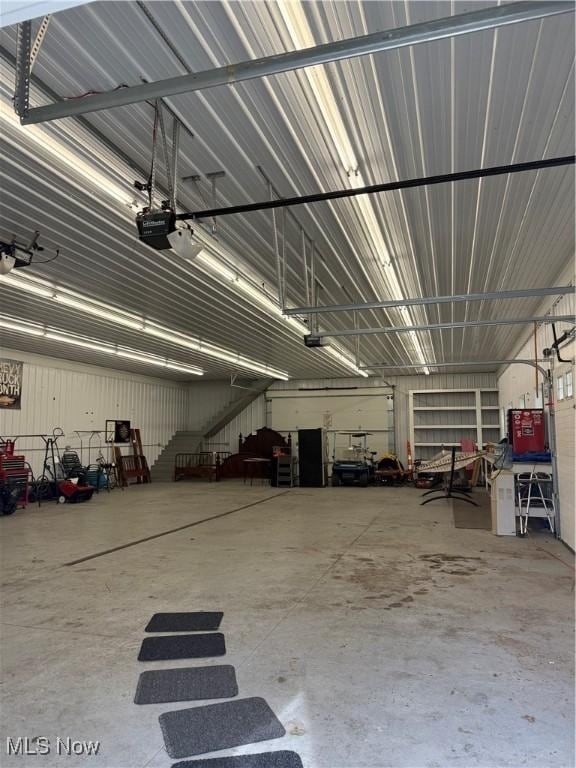 garage with a garage door opener and metal wall