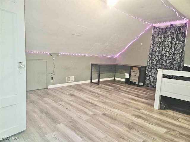 bonus room featuring hardwood / wood-style floors and lofted ceiling