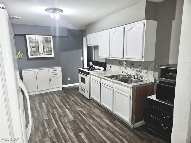 kitchen featuring sink, white cabinets, dark hardwood / wood-style floors, and white appliances