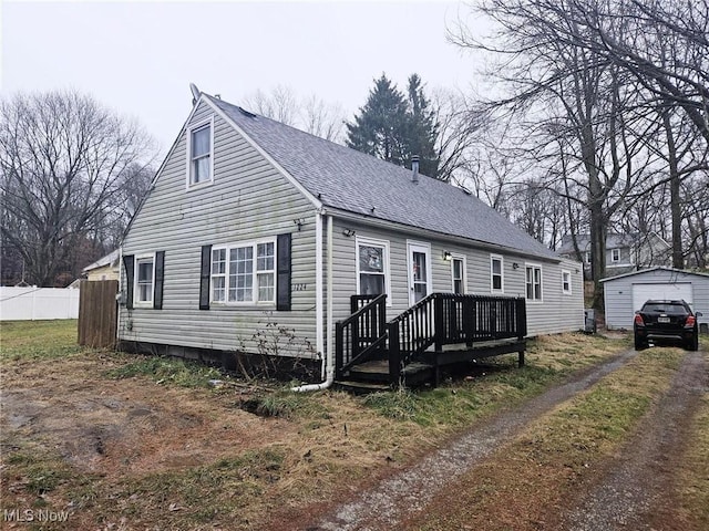 view of front of house with a garage and an outdoor structure