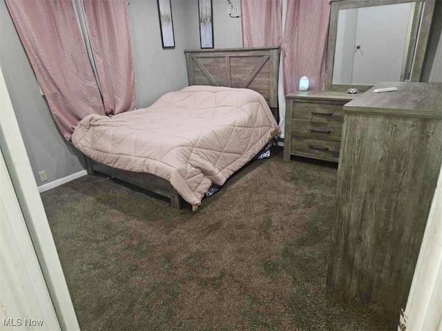 bedroom with dark colored carpet