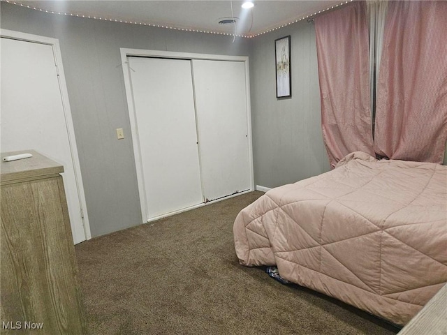 bedroom featuring dark carpet and a closet