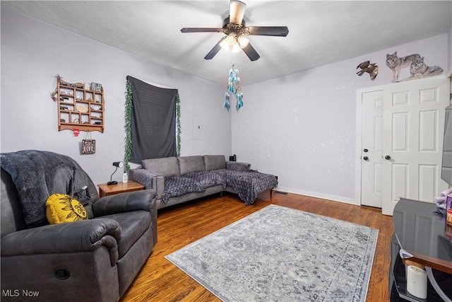 living room featuring ceiling fan and wood-type flooring