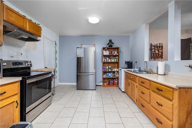 kitchen with sink, light tile patterned flooring, and appliances with stainless steel finishes