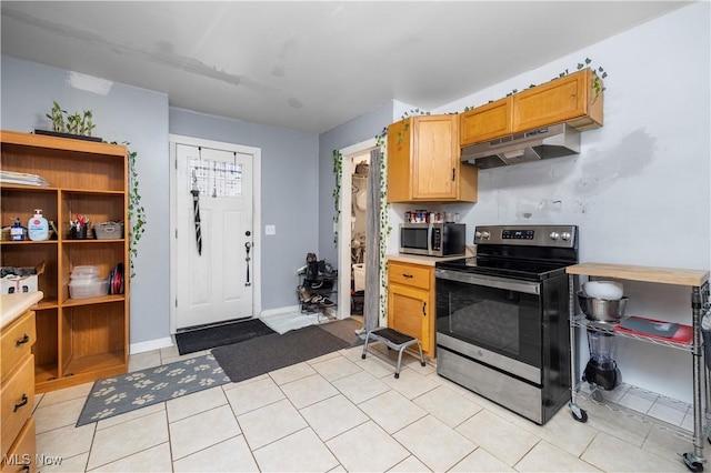 kitchen with light tile patterned floors and appliances with stainless steel finishes