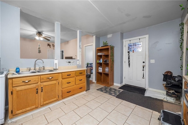 kitchen with light tile patterned flooring, sink, and ceiling fan