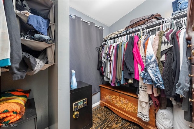 walk in closet with vaulted ceiling