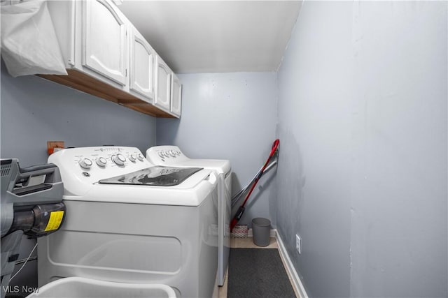 laundry area featuring independent washer and dryer and cabinets