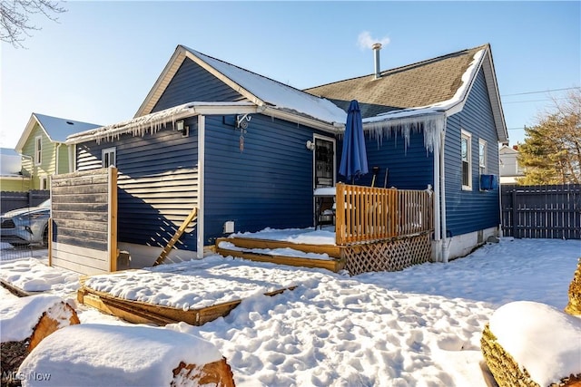 view of snow covered rear of property