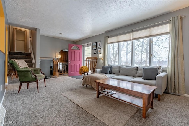 living room with carpet flooring and a textured ceiling