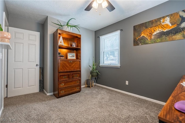 bedroom featuring ceiling fan, carpet floors, and a textured ceiling