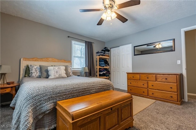 bedroom featuring carpet, ceiling fan, a textured ceiling, and a closet