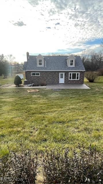 view of front of home with a patio and a front yard