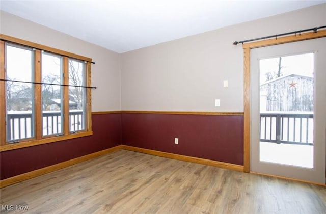 empty room with wood finished floors and baseboards