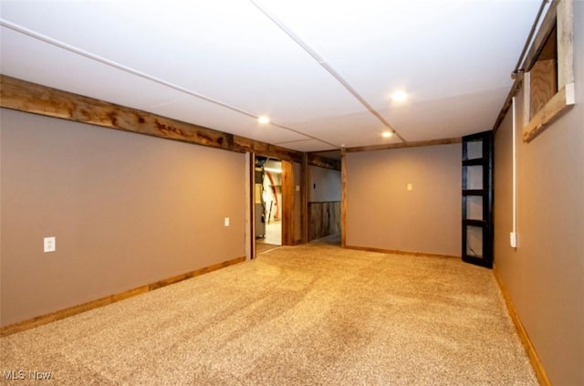 unfurnished room featuring carpet and baseboards