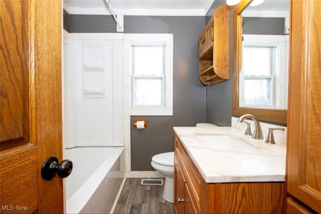 full bathroom with toilet, wood finished floors, vanity, and baseboards