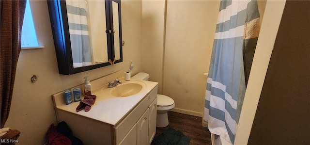 bathroom featuring vanity, hardwood / wood-style flooring, and toilet